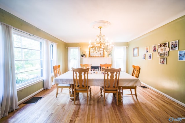 dining area featuring a notable chandelier and light hardwood / wood-style flooring