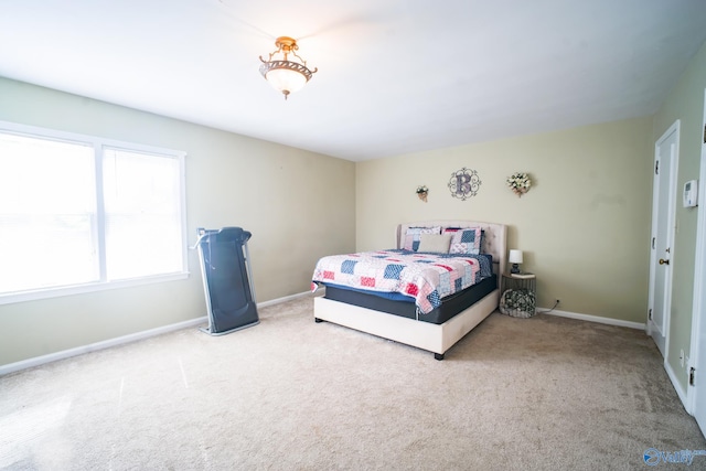 bedroom featuring light carpet