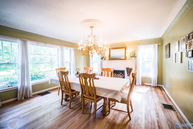 dining room featuring an inviting chandelier and light wood-type flooring