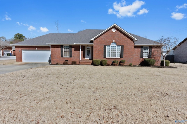 ranch-style home with a garage, concrete driveway, brick siding, and roof with shingles