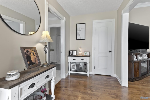 interior space with baseboards, dark wood finished floors, and a textured ceiling