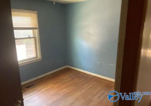 unfurnished room featuring hardwood / wood-style floors