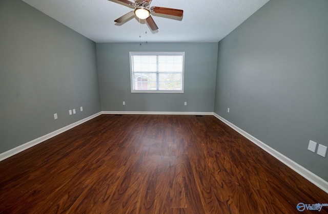 spare room with ceiling fan and dark hardwood / wood-style flooring