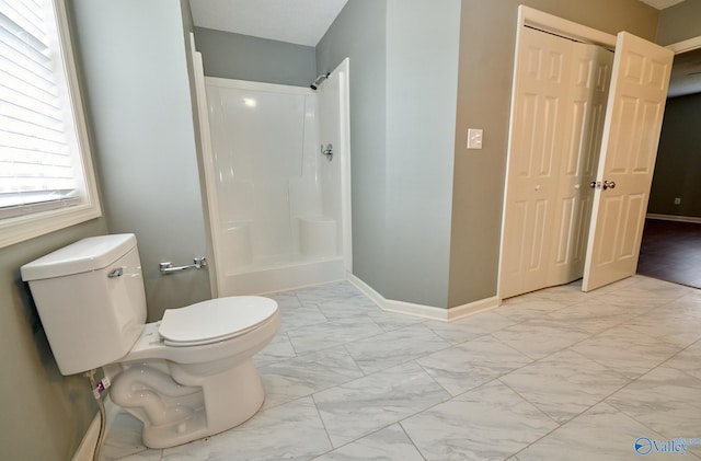 bathroom with toilet and a shower