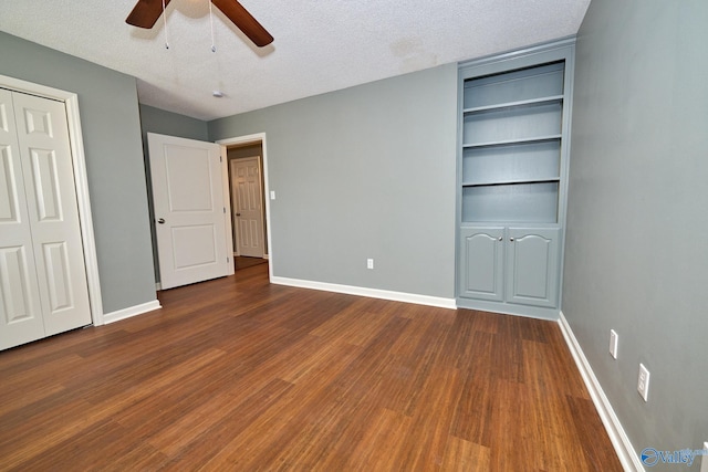 unfurnished bedroom with a textured ceiling, wood-type flooring, a closet, and ceiling fan