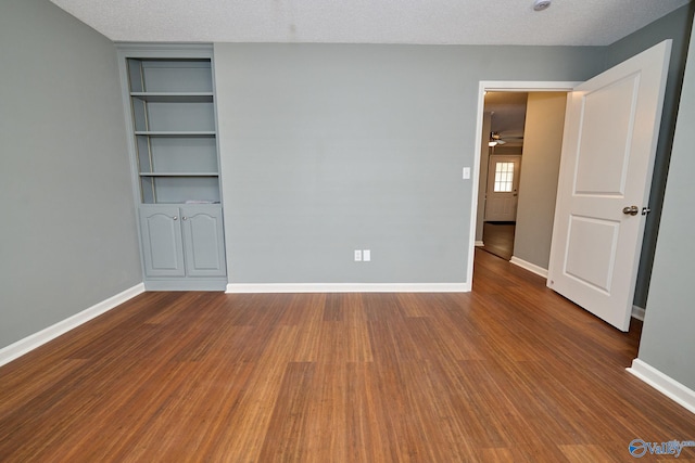 unfurnished bedroom with hardwood / wood-style floors and a textured ceiling