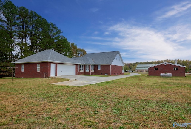 rear view of property featuring a garage and a lawn