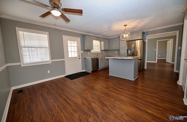 kitchen with a kitchen island, dark hardwood / wood-style floors, decorative light fixtures, gray cabinets, and appliances with stainless steel finishes