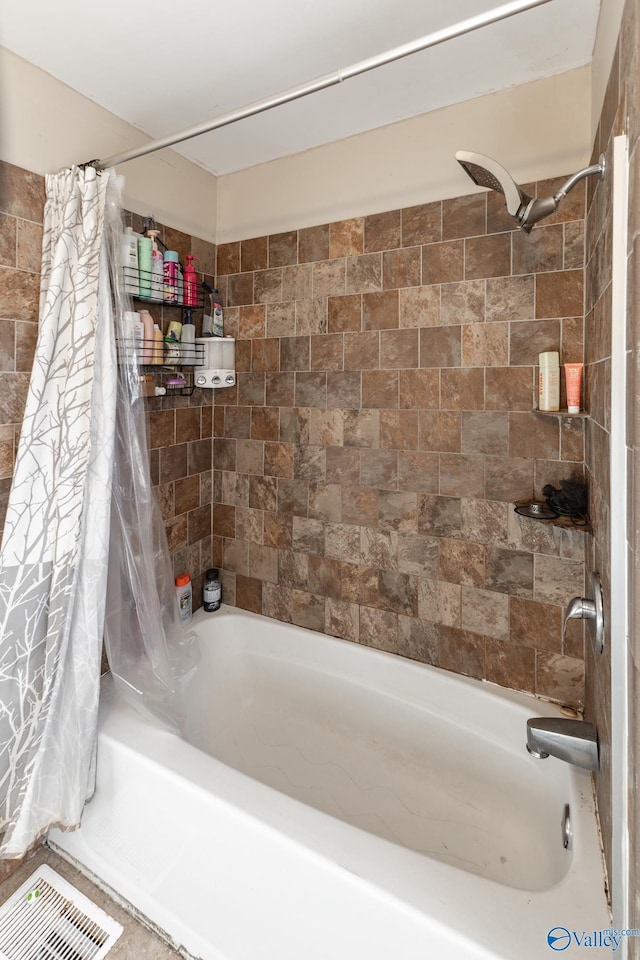 bathroom with shower / bath combination with curtain