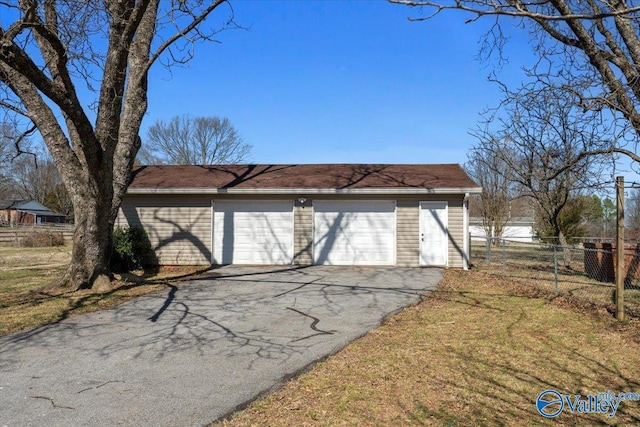 detached garage featuring fence