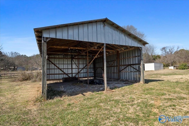 view of pole building featuring a lawn and a carport