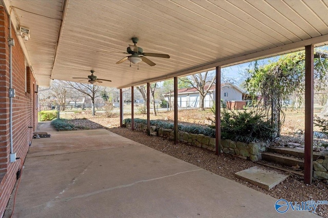 view of patio / terrace with fence and a ceiling fan