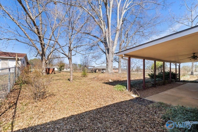 view of yard featuring a patio area, fence, and a ceiling fan