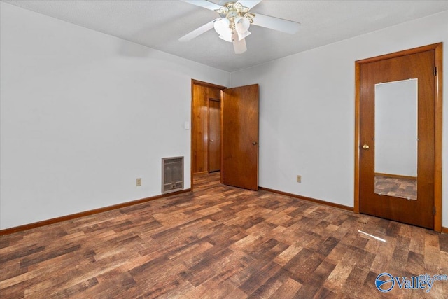 unfurnished room with visible vents, ceiling fan, baseboards, and wood finished floors