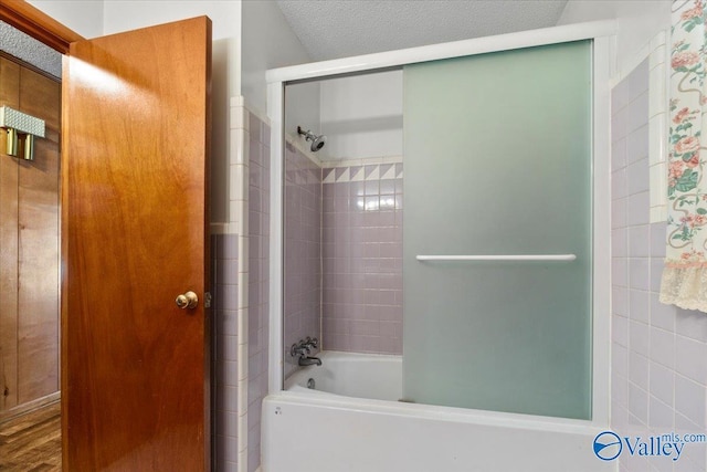 bathroom featuring a textured ceiling and shower / bathtub combination