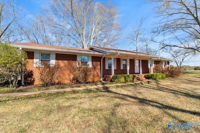 ranch-style house featuring brick siding, a porch, and a front yard