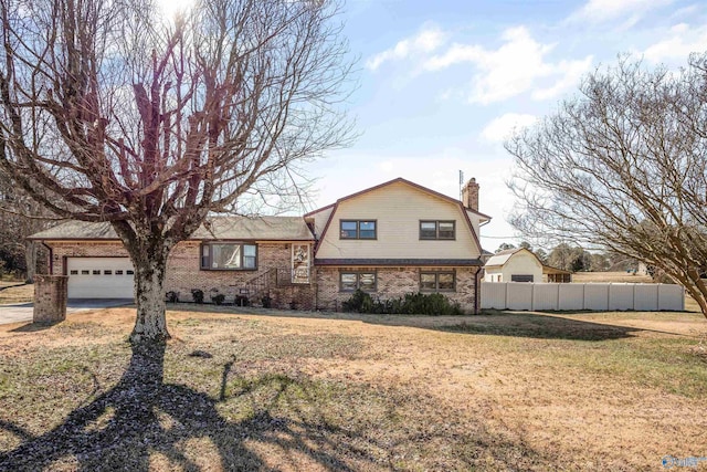 view of front of house with a garage and a front yard