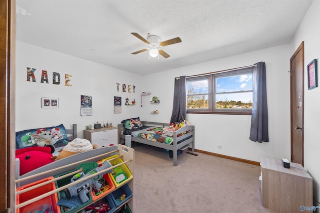 carpeted bedroom with a textured ceiling and ceiling fan