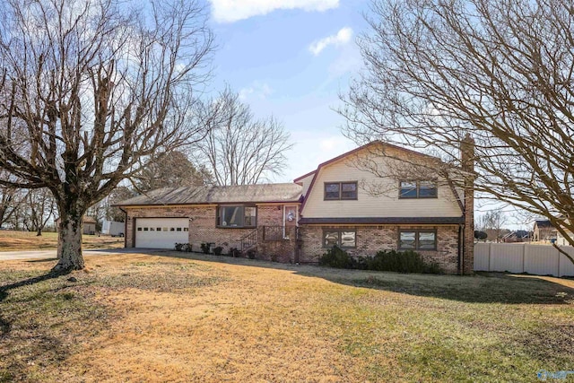 split level home featuring a garage and a front yard