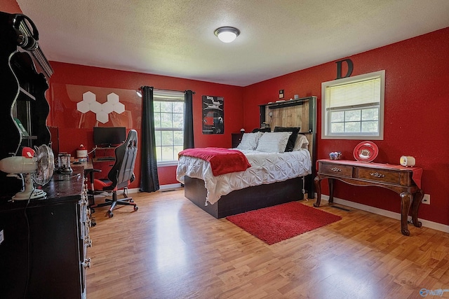 208 Burgess Ave, Rainsville, AL 35986 - bedroom with wood finished floors, a textured ceiling, and baseboards