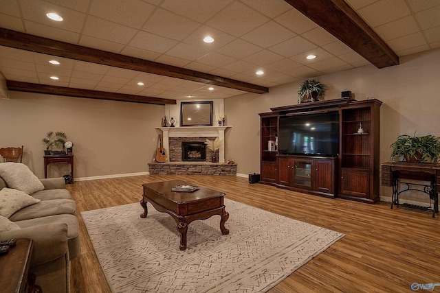 208 Burgess Ave, Rainsville, AL 35986 - living room featuring wood finished floors, beamed ceiling, a stone fireplace, baseboards, and recessed lighting