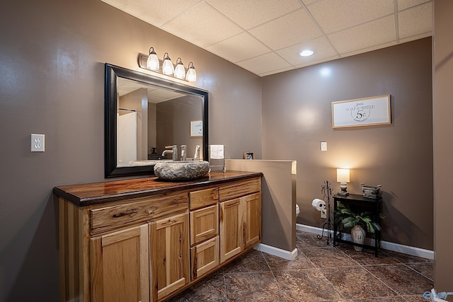 208 Burgess Ave, Rainsville, AL 35986 - bathroom with vanity, baseboards, a drop ceiling, and recessed lighting