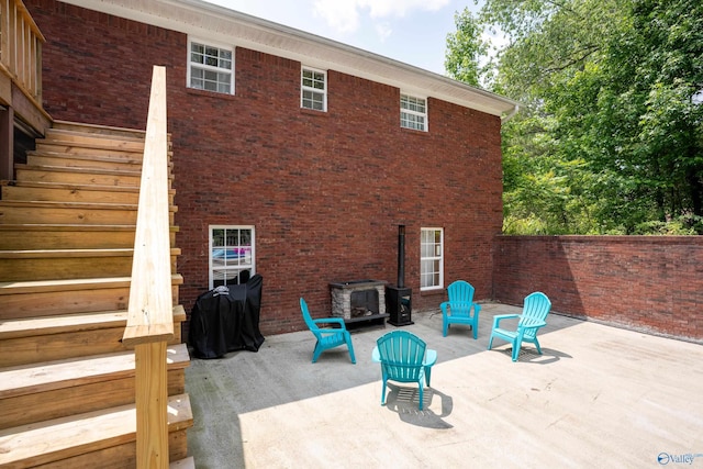 208 Burgess Ave, Rainsville, AL 35986 - rear view of property with a patio area, stairs, and brick siding