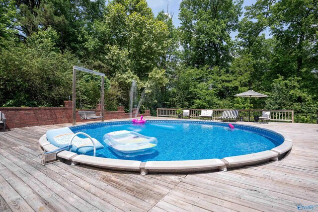 208 Burgess Ave, Rainsville, AL 35986 - swimming pool with view of scattered trees and a deck