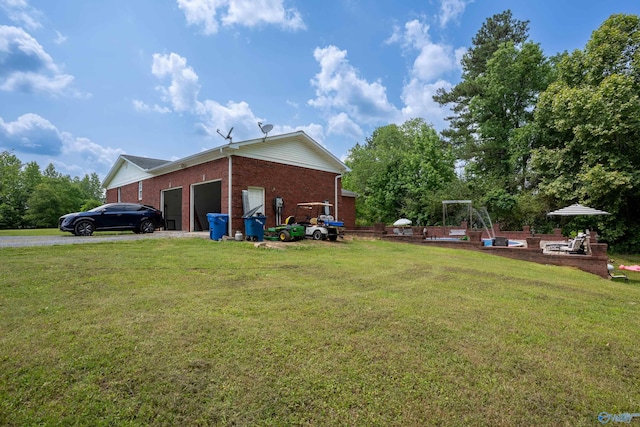 208 Burgess Ave, Rainsville, AL 35986 - view of side of home with brick siding, a yard, an attached garage, and driveway
