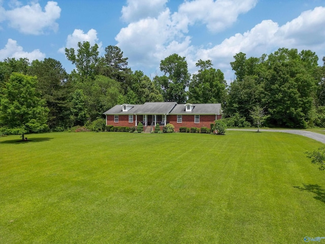 208 Burgess Ave, Rainsville, AL 35986 - view of front of house with a front lawn, a wooded view, and brick siding
