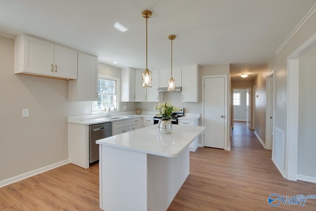 kitchen with light wood finished floors, white cabinetry, appliances with stainless steel finishes, and light countertops