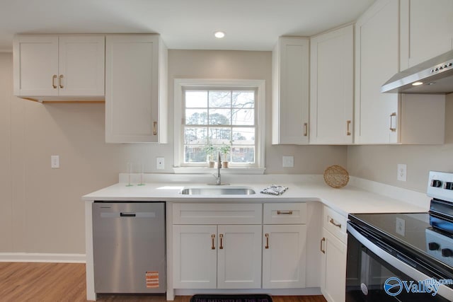 kitchen featuring white cabinets, stainless steel appliances, a sink, and exhaust hood