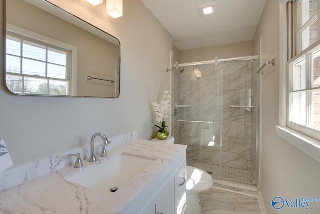 bathroom featuring a stall shower, marble finish floor, a healthy amount of sunlight, and toilet