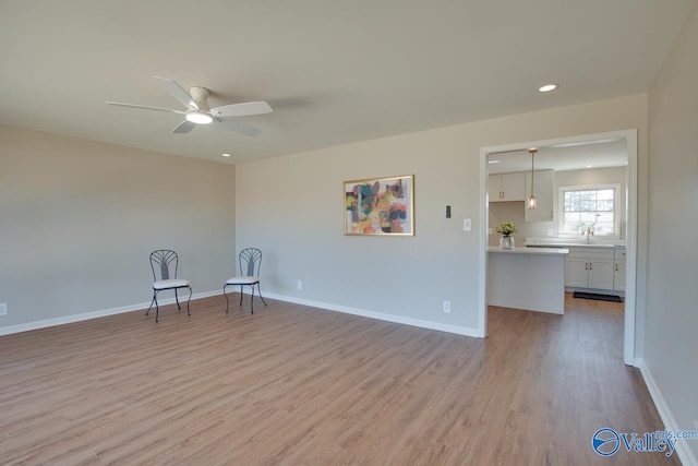 unfurnished room featuring light wood-style floors, recessed lighting, ceiling fan, and baseboards