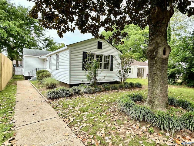 view of home's exterior featuring fence