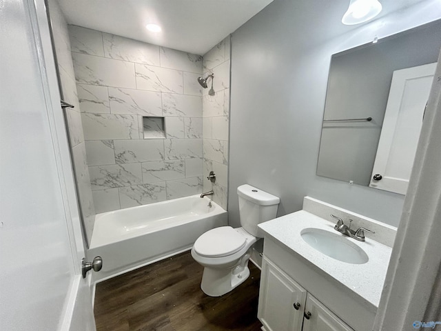 bathroom with vanity, shower / tub combination, wood finished floors, and toilet