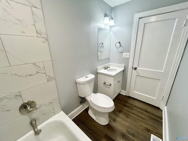 bathroom featuring visible vents, wood finished floors, vanity, baseboards, and toilet