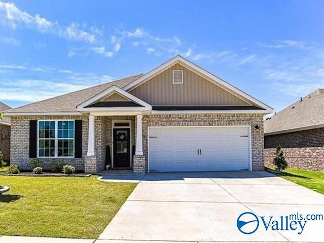 craftsman-style home with a garage and a front lawn