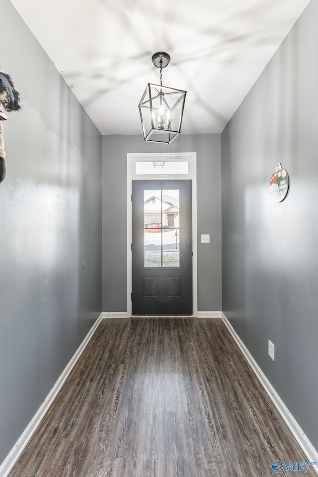 entryway featuring a chandelier and dark hardwood / wood-style floors