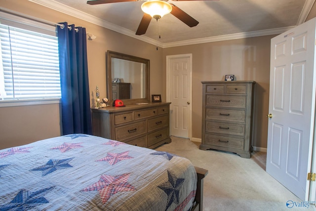 carpeted bedroom with ceiling fan and ornamental molding