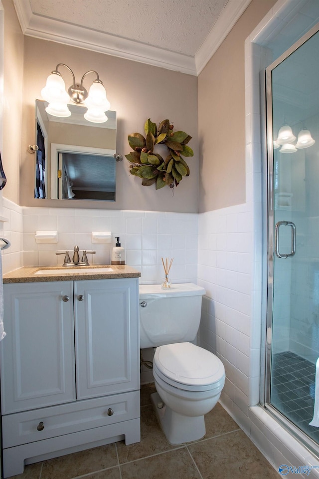 bathroom featuring vanity, a shower with door, crown molding, tile patterned floors, and a textured ceiling