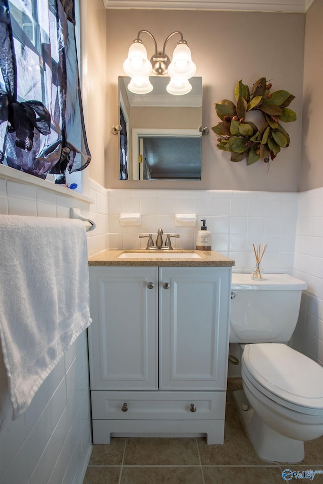 bathroom with vanity, tile walls, tile patterned floors, and toilet