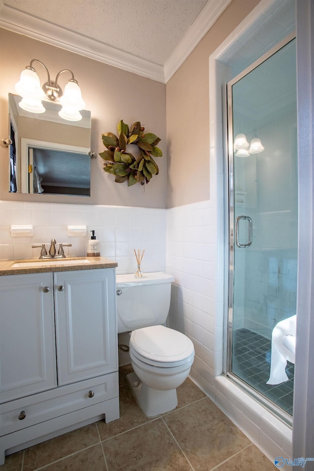 bathroom with vanity, an enclosed shower, ornamental molding, a textured ceiling, and toilet