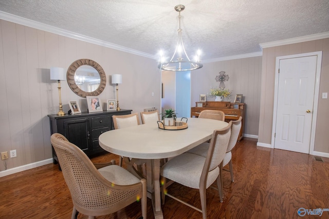 dining room with dark wood-type flooring, a textured ceiling, and a notable chandelier