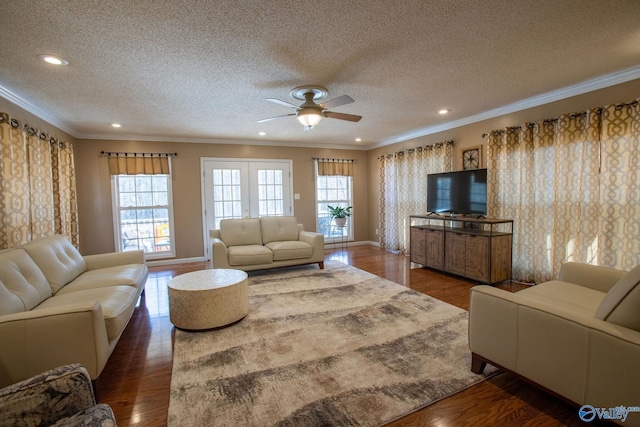 living room featuring crown molding, dark hardwood / wood-style floors, and a healthy amount of sunlight