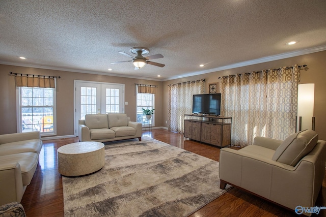 living room featuring a wealth of natural light, ornamental molding, dark hardwood / wood-style floors, and ceiling fan