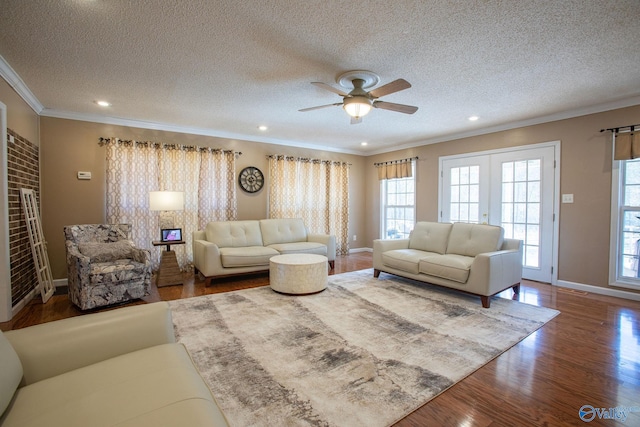 living room with french doors, crown molding, a textured ceiling, ceiling fan, and hardwood / wood-style floors