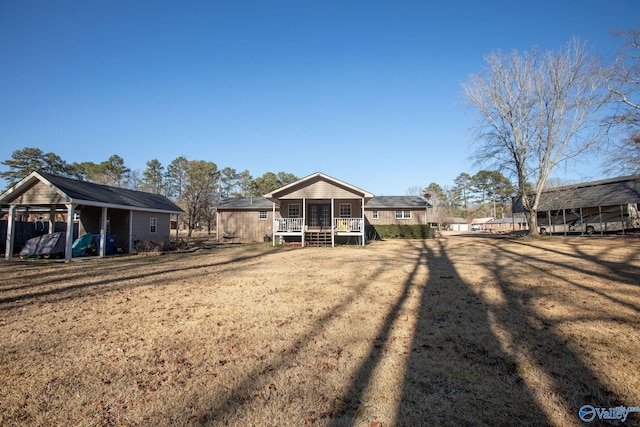 view of yard featuring a sunroom and a carport