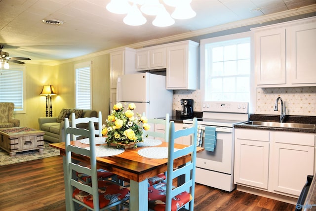 kitchen with ornamental molding, white appliances, sink, white cabinets, and dark hardwood / wood-style floors