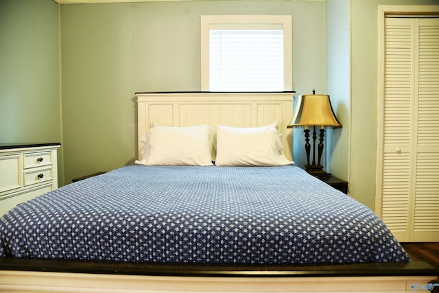 bedroom with wood-type flooring and a closet